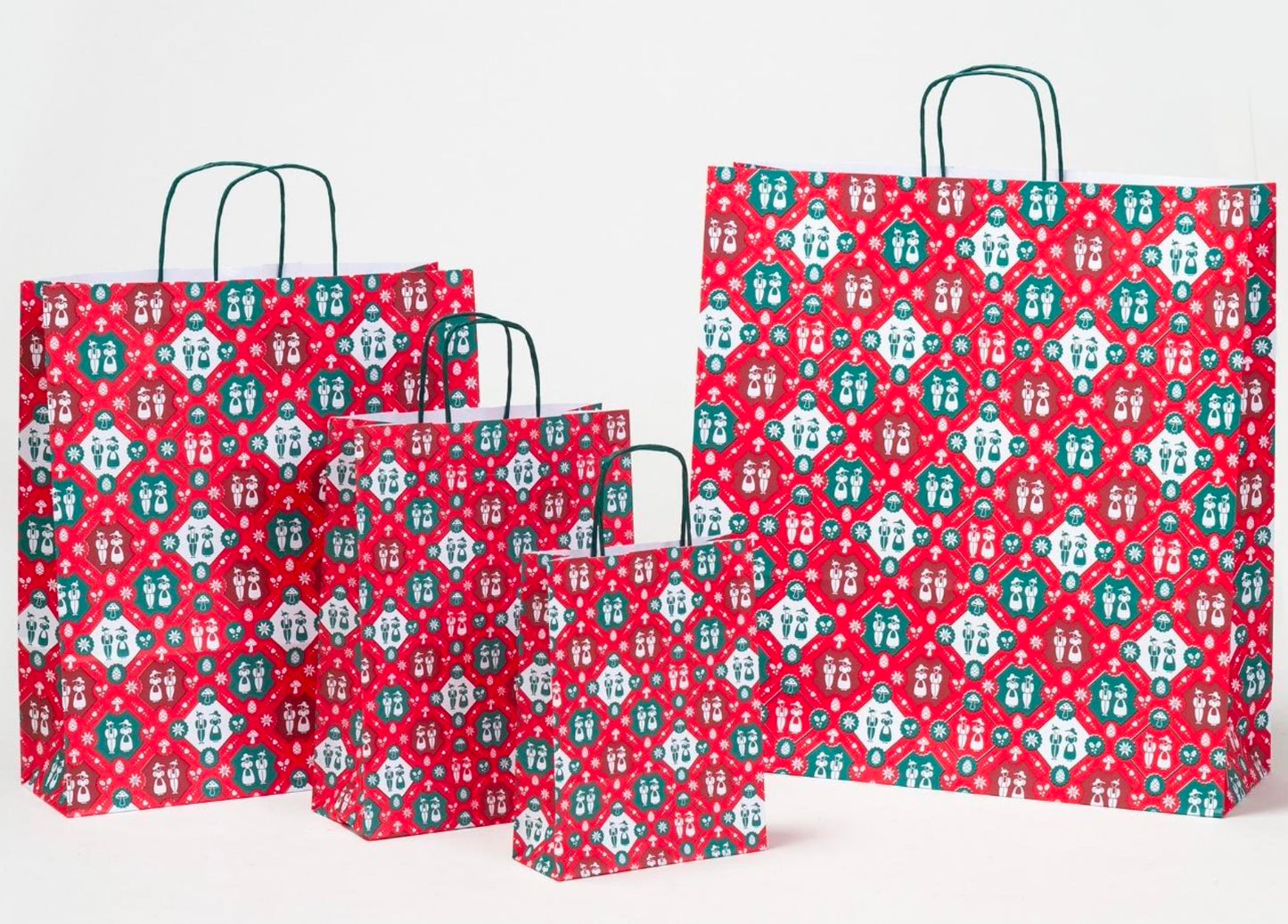 Papierkordeltaschen mit Trachtenmotiv in verschiedenen Größen in der Papiertütenfarbe Rot mit grünen Papierkordeln zum Tragen der Tasche